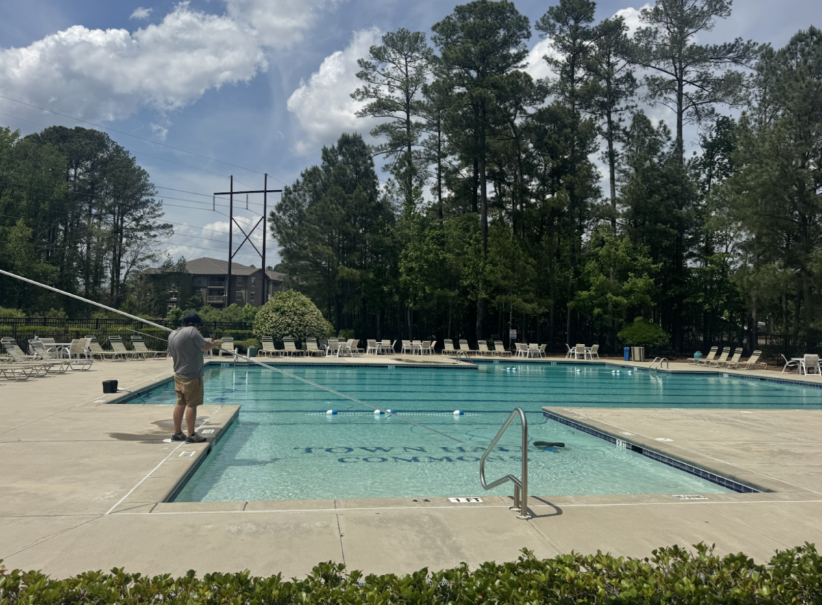Town Hall Commons Pool getting ready for opening by vacuuming the pool, making sure it is all clean and setting up the shallow vs deeper areas of the pool.